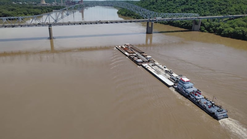 Barges, a crane, and other equipment for the Brent Spence Bridge Corridor Project are expected...