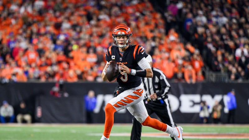 Cincinnati Bengals quarterback Joe Burrow (9) scrambles from pressure during an NFL football...