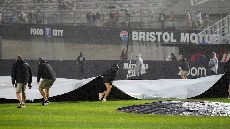 Member of the ground cover the field during a rain delay in the first inning of the MLB...