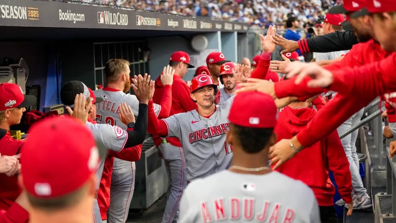Cincinnati Reds right fielder Austin Hays (12) celebrates after scoring on a two-RBI single...