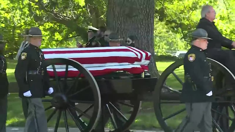 Hamilton County Deputy Sheriff Larry Henderson's casket arrives at Spring Grove Cemetery.