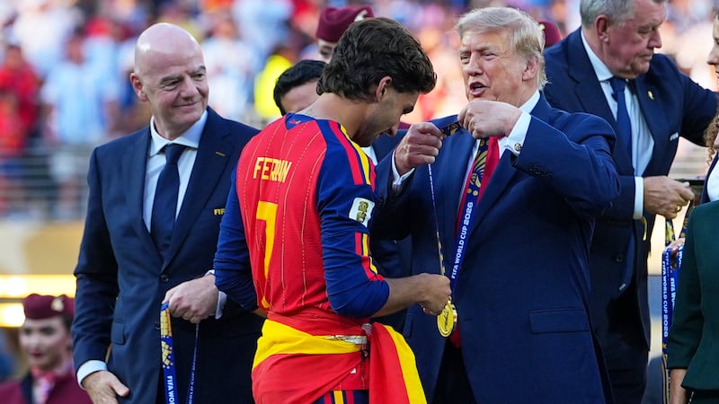President Donald J. Trump gives Spain's Ferran Torres (7) winners metal during the World Cup...