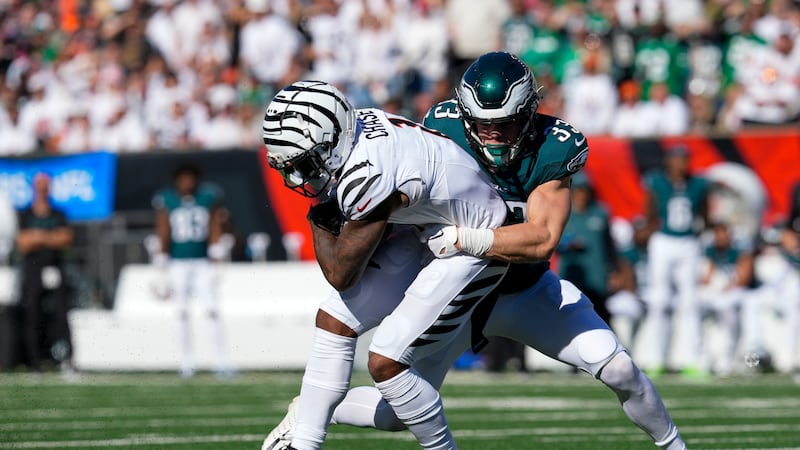 Cincinnati Bengals wide receiver Ja'Marr Chase, left, is tackled by Philadelphia Eagles...