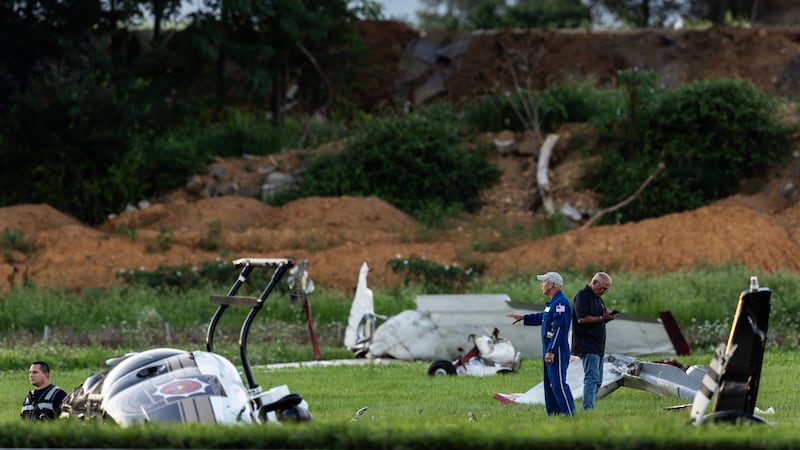 Authorities investigate a crash between a Pennsylvania State Police helicopter and a small...