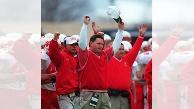 Beechwood head coach Mike Yeagle and other staff members raise their arms as the Tigers scored...