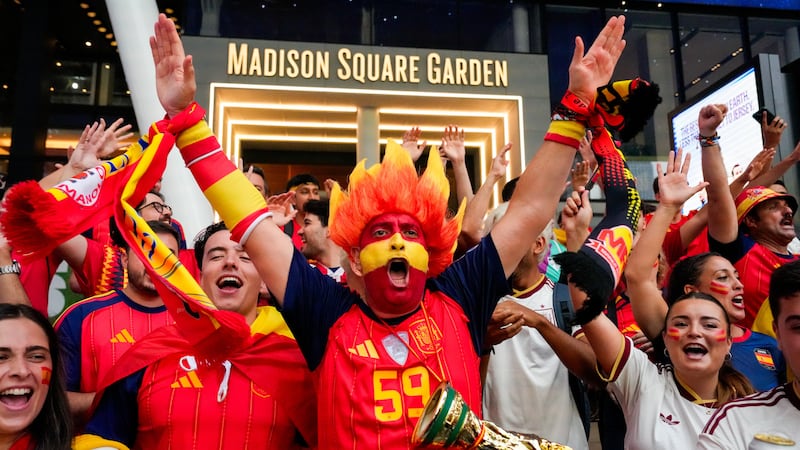 Spain fans gather for a rally on the eve of the World Cup final soccer match in New York's...