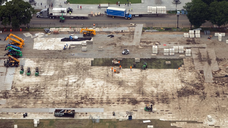 FILE - Workers dismantle structures from Salute to America, an Independence Day event honoring...