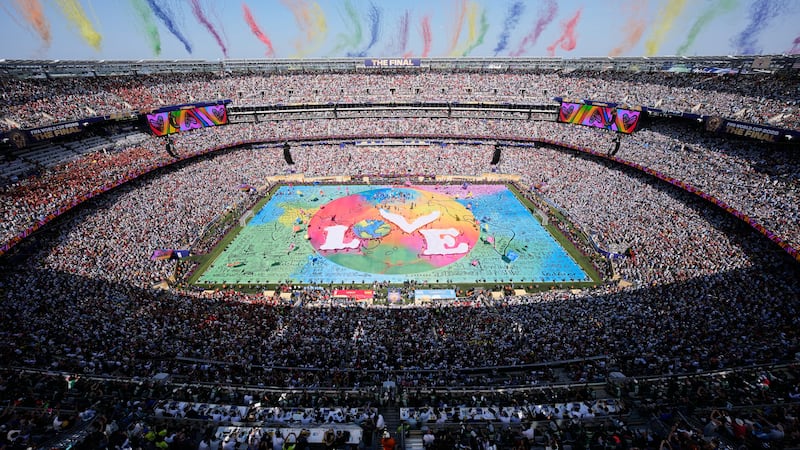 Dancers perform as colorful smoke rises above the stadium during the halftime show at the...