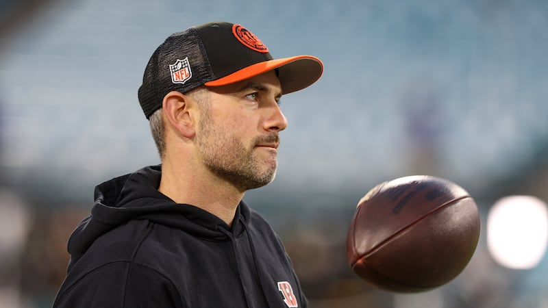 Cincinnati Bengals quarterbacks coach Dan Pitcher warms up before an NFL football game against...
