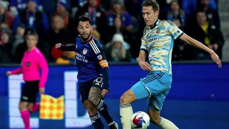 FC Cincinnati midfielder Luciano Acosta (10) crosses the ball as Philadelphia Union defender...