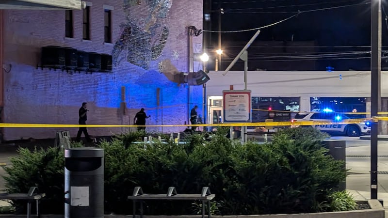 Cincinnati police search for evidence at the scene of a quadruple shooting in Northside early...