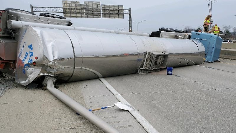 The contents in the semi’s tanker have to be transferred before the overturned truck can be...