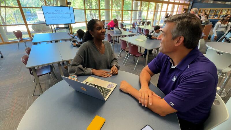 Marietta City Schools Superintendent Dr. Grant Rivera talks with a senior at Marietta High...