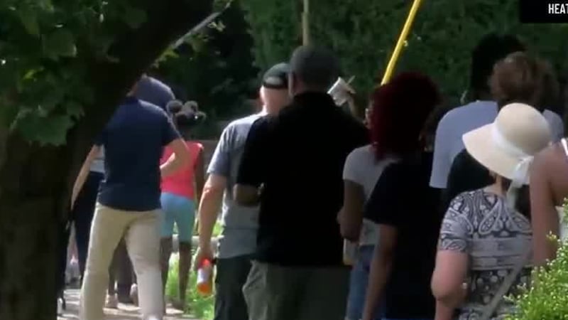 Community members and city leaders march through neighborhood streets days after 18-year-old...