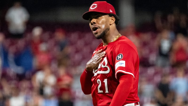 Cincinnati Reds pitcher Hunter Greene reacts after striking out the last batter of a baseball...