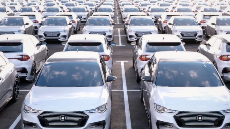 A row of cars lined up in a parking lot