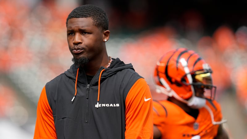 Cincinnati Bengals wide receiver Tee Higgins, left, stands on the sidelines prior to an NFL...