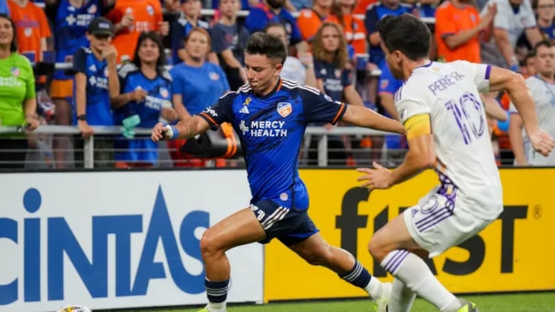 FC Cincinnati midfielder Alvaro Barreal (left) dribbles past Orlando City SC midfielder...