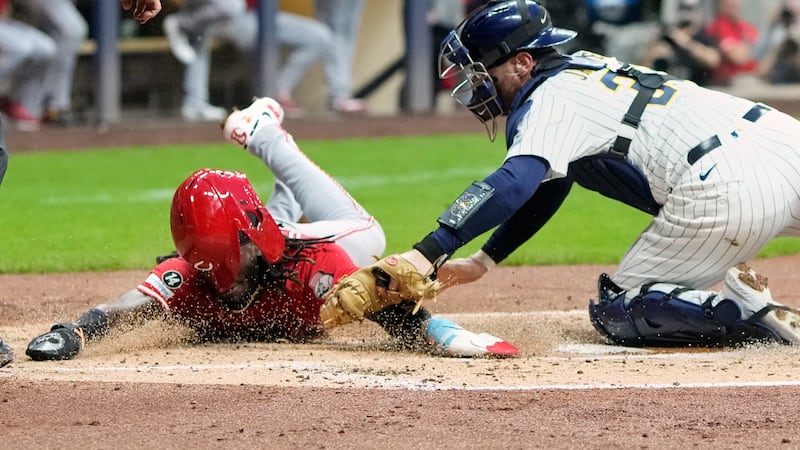 Milwaukee Brewers catcher Danny Janse tags out Cincinnati Reds' Elly De La Cruz at home during...