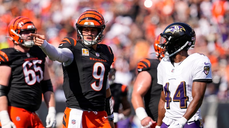 Cincinnati Bengals quarterback Joe Burrow (9) gestures in front of Baltimore Ravens cornerback...