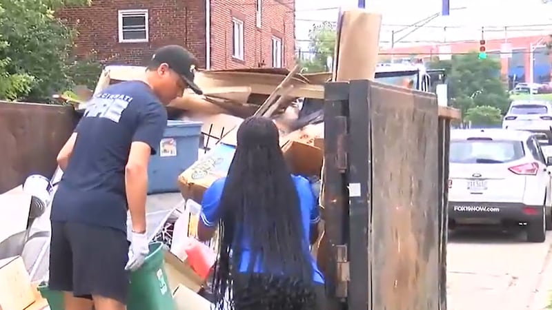 Mayor Aftab Pureval helping clean Oakley after flooding in mid-July