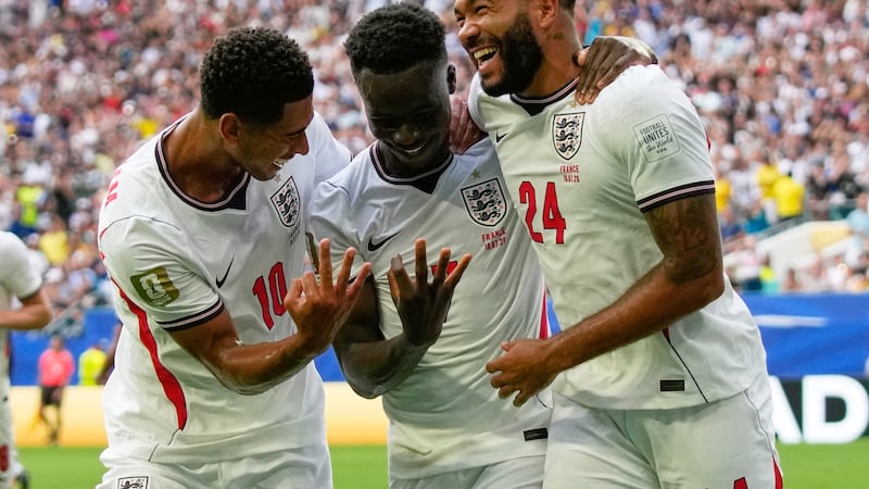 England's Bukayo Saka (7) is congratulated by Jude Bellingham (10) and Reece James (24) after...