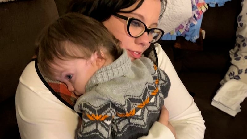 Carter Twigg holds her son Owen